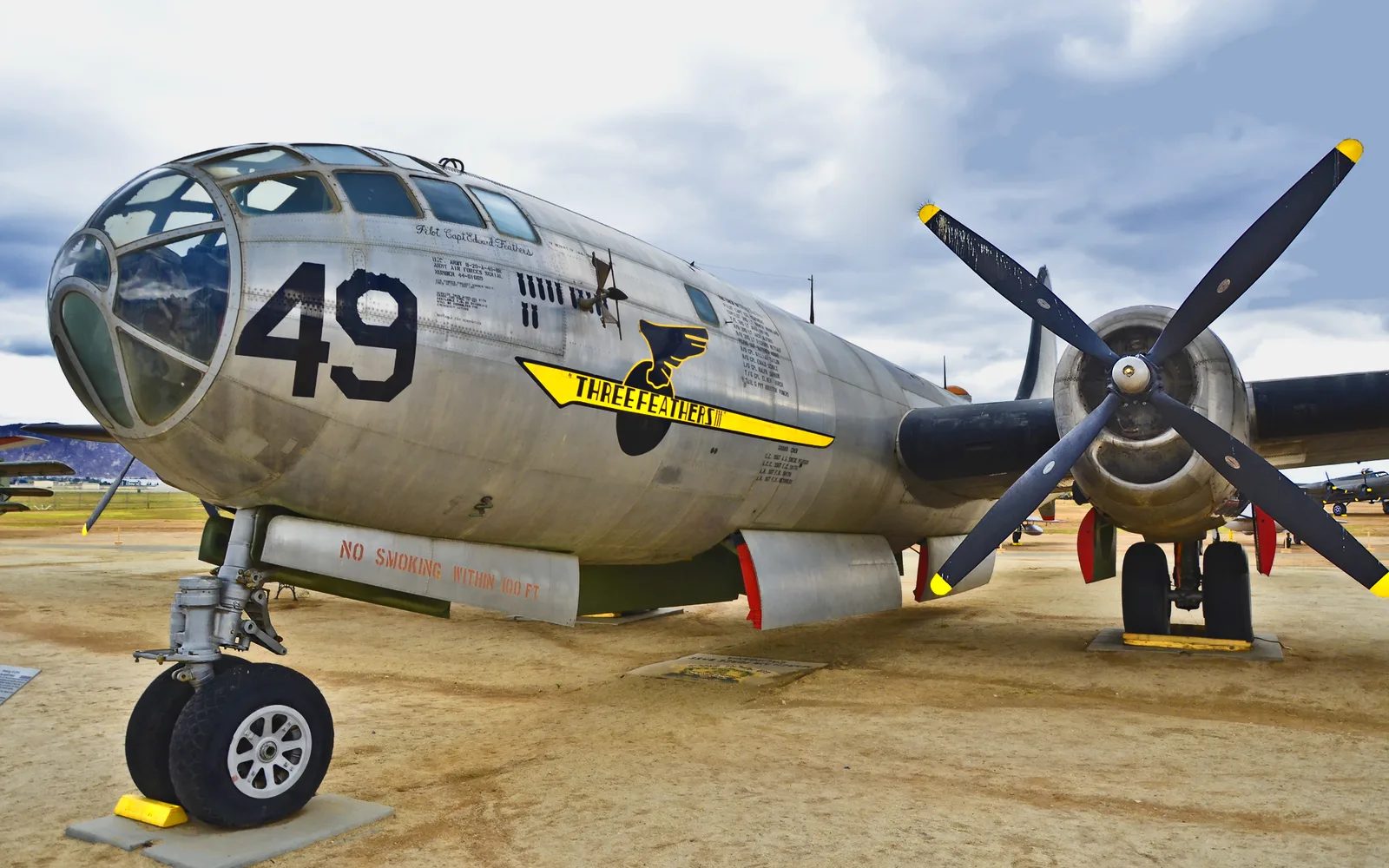 Historic silver B-29 aircraft displayed outdoors at March Field Air Museum under a clear sky